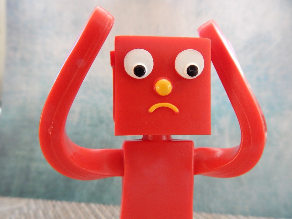 red gumby-like creature holding head in worry